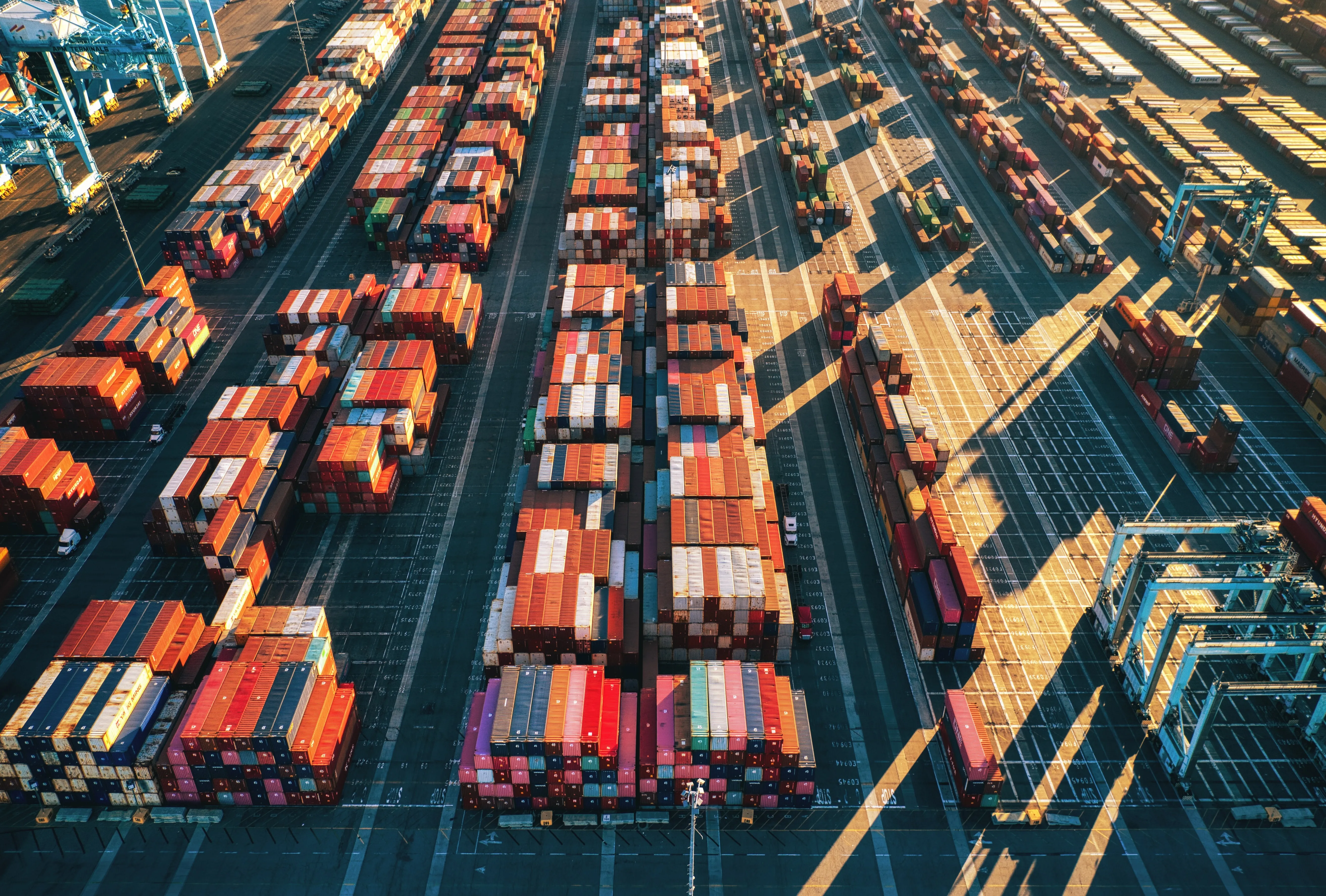 Overview of a shipping yard full of containers at port.